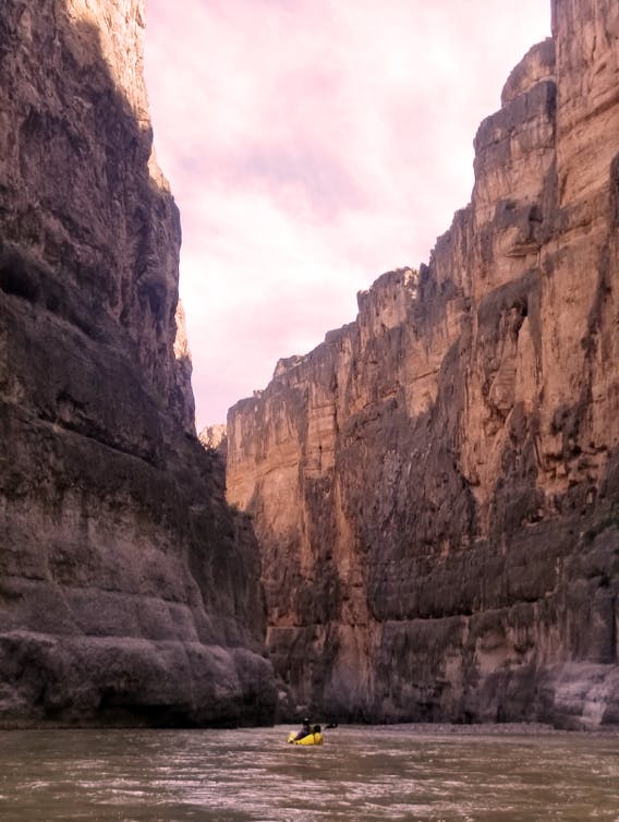 Sarah and Tom packrafting on a calm section of the Rio Grande, offering a unique perspective of the desert landscape and wildlife.