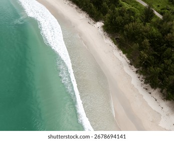 Close-up of very white sand with a slight breeze blowing. The focus is on the texture of the sand itself.