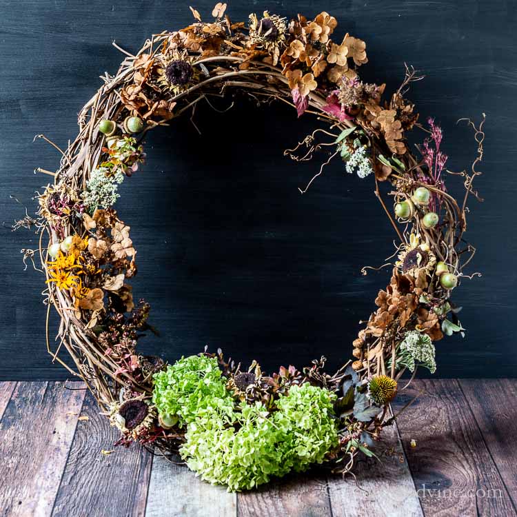 hands crafting foraged wreath farmhouse table