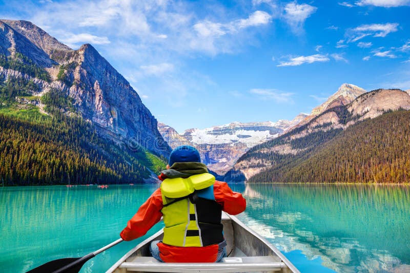 Lake Louise surrounded by towering mountains and evergreen trees