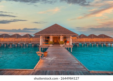 Sunset view of a Maldives water villa with a private pool and deck, showcasing the romantic atmosphere
