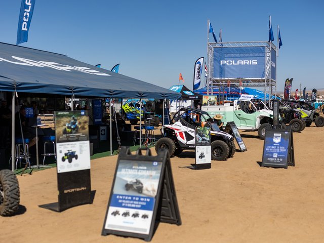 Group of volunteers cleaning up the desert using quad bikes