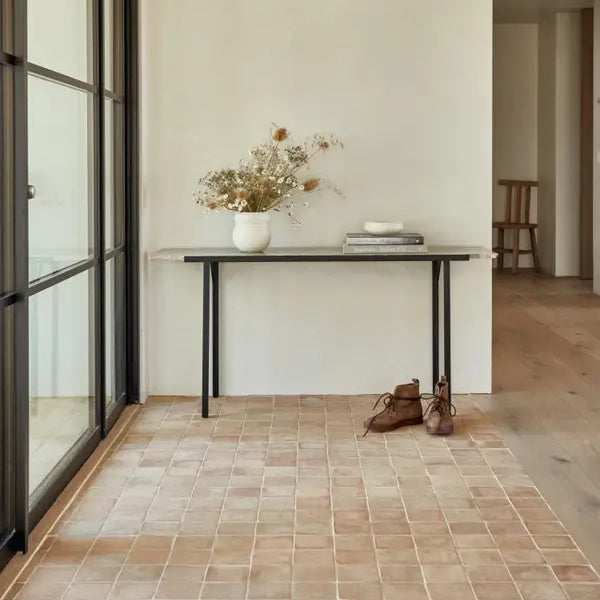 A well-organized mudroom featuring a bench with shoe storage, hooks for coats, and storage bins.