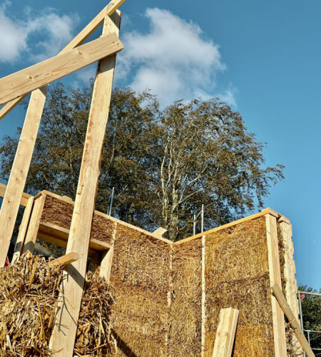 Packing straw insulation into wall cavities