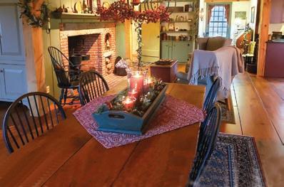 A cozy reading nook with an armchair draped in a knitted blanket, a floor lamp providing warm light, and a small side table with books and a mug, creating a comfortable and inviting space.