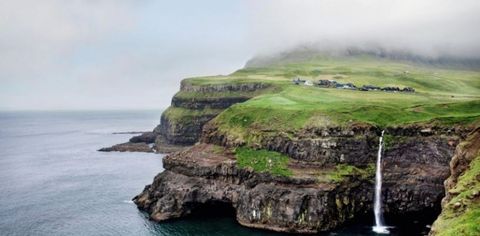 A family carefully presenting Faroese chocolates to their host during a