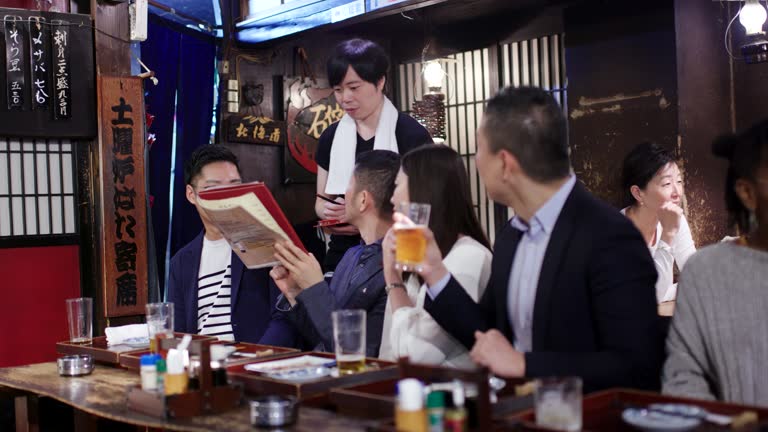 A close-up of yakitori skewers grilling over charcoal