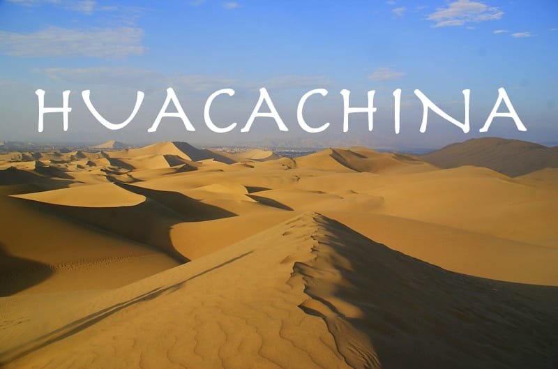 Sandboarder descends a dune in Huacachina, Peru, showing their focused expression and the vastness of the dune landscape under the midday sun