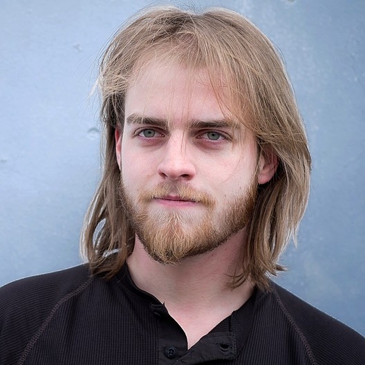 Promotional artwork from the mod's creator, Kinggath, available on Nexus Mods. The artwork features key characters from the mod's storyline, like Jake Evans, or showcases the mod's central city-building features in a dramatic, stylized manner, in high resolution with professional-grade rendering quality.