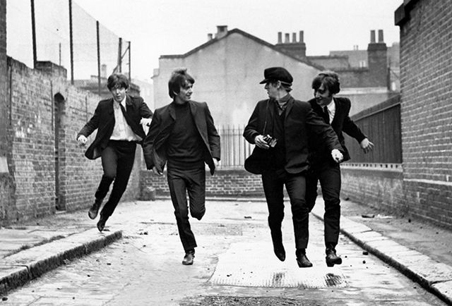 A promotional still from 'A Hard Day's Night' featuring The Beatles in their iconic outfits.