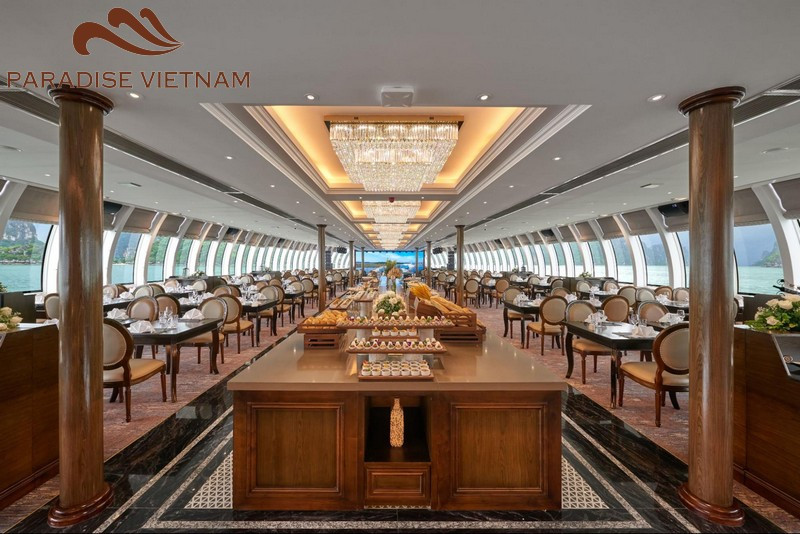 Overhead shot of participants in a cooking class on a junk boat, focusing on the hands preparing fresh spring rolls