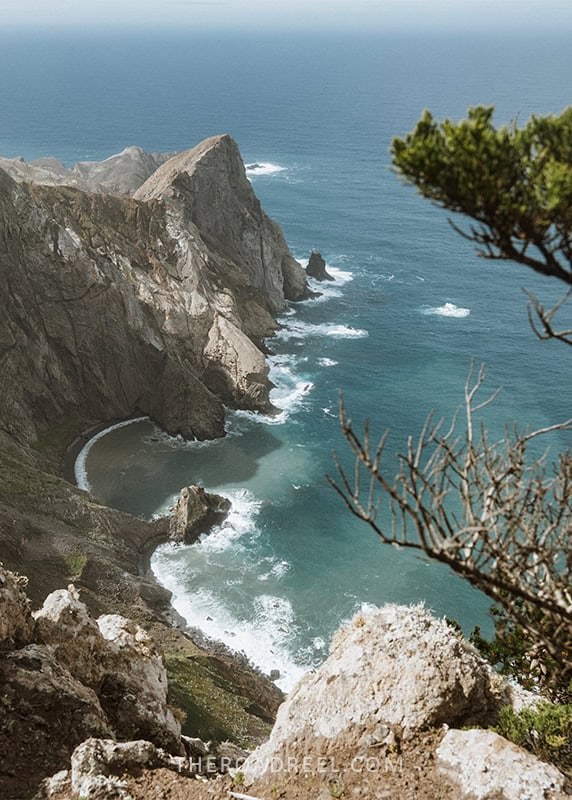 A winding coastal road next to the ocean.