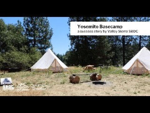 Vintage style canvas tent nestled in the woods of Yosemite's Upper Pines Campground, showing sunlight streaming through the trees