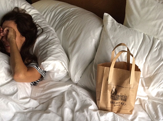 A cityscape at sunset from a rooftop bar.