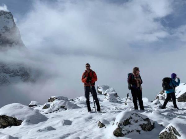 The night sky above Mauna Kea Observatories, with the stars appearing as streaks due to the time-lapse photography, highlighting the vastness of space and the importance of the observatories.