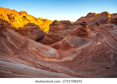 The Wave, Arizona at dawn, showcasing the swirling sandstone formations under the rising sun
