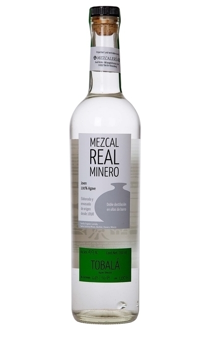 A close-up shot of mezcal dripping from the still at Real Minero, emphasizing the craftsmanship and traditional distillation process.