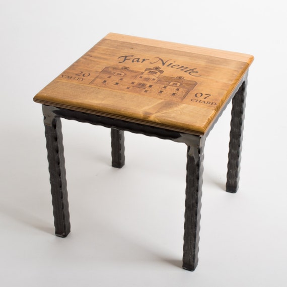 A small, repurposed wooden crate used as a side table, holding a mug of tea and a book.