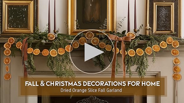 Three vintage brass candlesticks of varying heights, each holding an amber-colored taper candle, arranged on a farmhouse mantel to create a warm and inviting glow for fall.