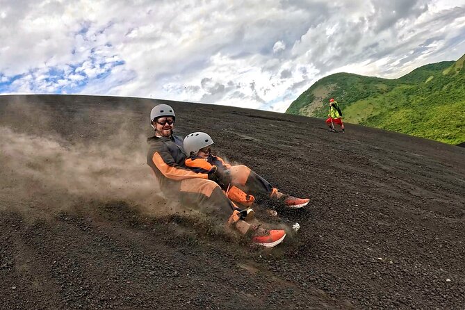 A wide shot of Cerro Negro with volcano boarders descending.