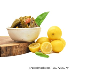 Vinegar being poured over orange peels inside a glass jar on a rustic wooden table