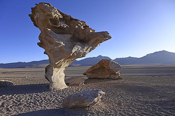 Hikers traversing the surreal landscape of Valle de la Luna in the Atacama Desert