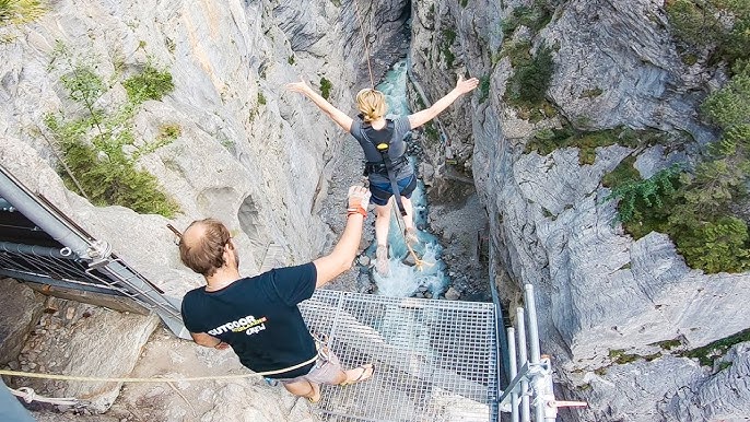 Wide-angle shot showcasing the narrowness and depth of the Glacier Canyon, with the swing visible in the foreground.