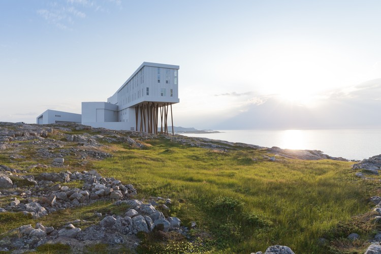 The Fogo Island Inn perched on the rocky coastline, showcasing its unique architecture and integration with the natural landscape.