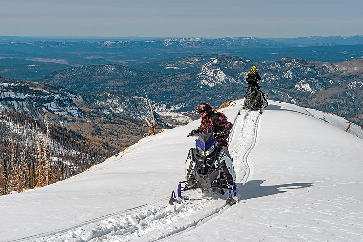 Ice diver emerging from frozen lake in Rovaniemi, Finland, surrounded by snow and ice