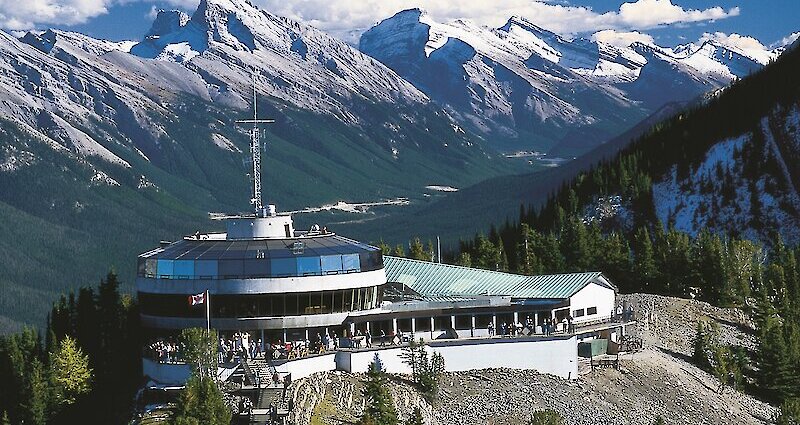 Families enjoying snow tubing at Mount Norquay, demonstrating a fun winter activity with stunning mountain views