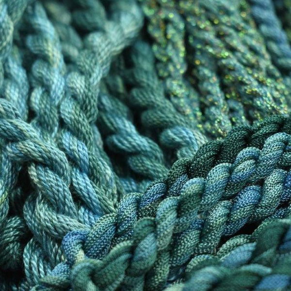 Hands stitching fabric close up stitches