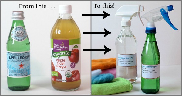 Hand holding a spray bottle of citrus cleaner, spraying it on a surface.