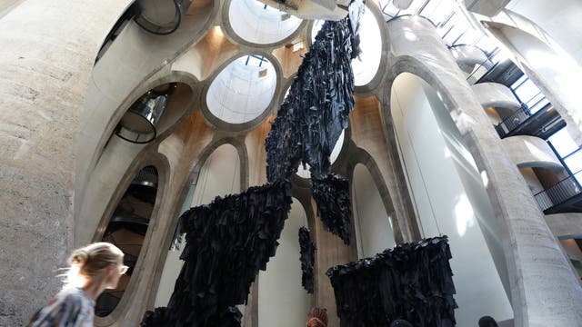 Close-up of the geometric windows, emphasizing their unique shape and the reflections of the city