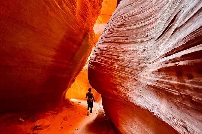 A couple embracing inside The Narrows, with sunlight streaming down between the towering sandstone walls, showcasing the beauty and intimacy of the hike.