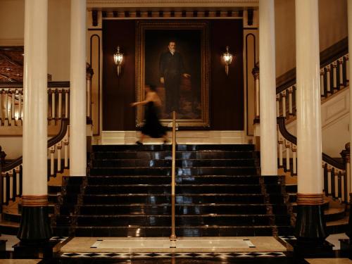 The Driskill's grand staircase, showing the intricate woodwork and stained glass
