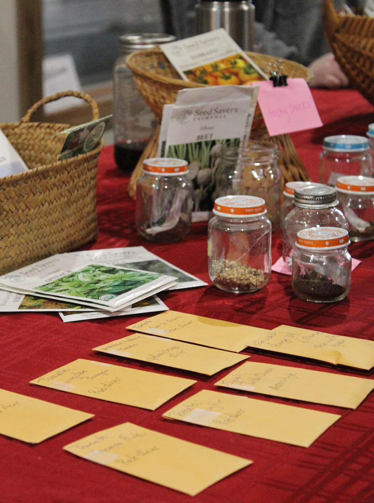 group people exchanging seed packets outdoors sunny