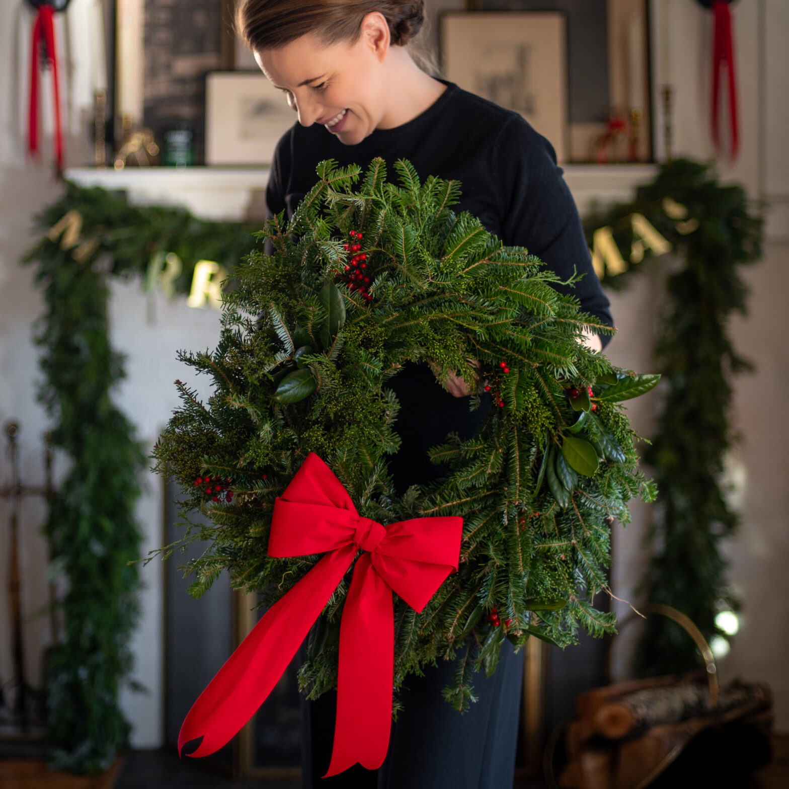 hands assembling evergreen garland twine