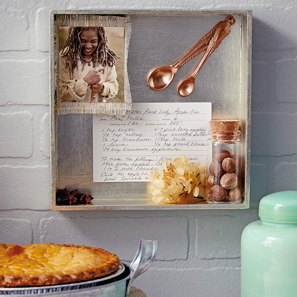 A close-up of a vintage rolling pin with patterned texture displayed against other baking supplies