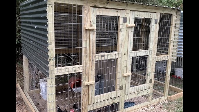 Gloved hands meticulously stapling chicken wire to the frame of a chicken tractor, wire gleaming in sunlight.