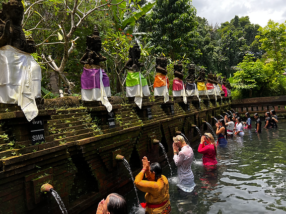 Anika's hands holding an offering during Melukat