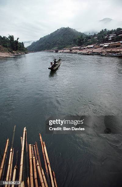 The stunning turquoise pools of Kuang Si Falls, with sunlight filtering through the jungle canopy.