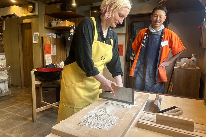 The noodle-making process and of individuals enjoying the freshly made soba