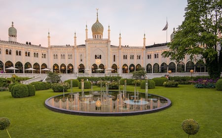 Marcus listening to vinyl in his room at Hotel Sanders, with the Poul Henningsen lamp providing a warm glow.