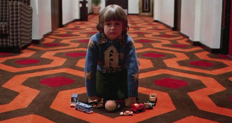 Jack Torrance at his typewriter, a symbol of his isolation, creative frustration, and descent into madness, mirroring the themes of guilt and secrecy associated with the moon landing theory.