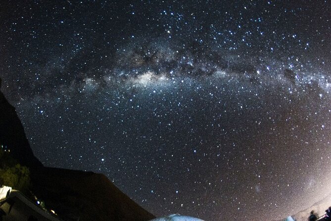 Javier silhouetted against the Elqui Domos at night.
