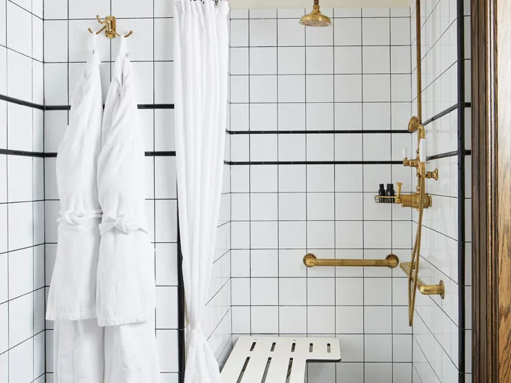 Hotel bathroom with marble tiling and rain shower