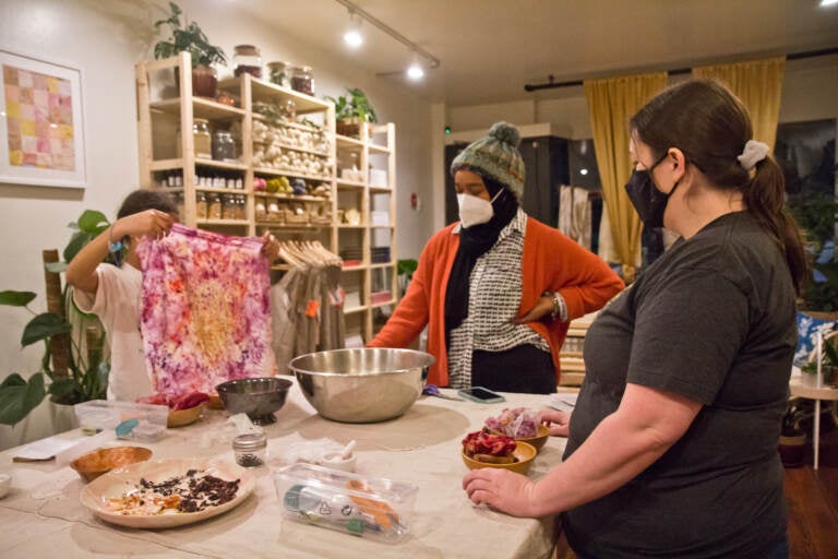 Rinsing naturally dyed fabric in cold water.
