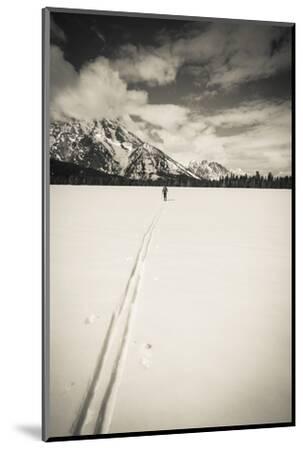 Close-up of an ice ax penetrating blue ice at Mojstrana, illustrating the challenge and reward of ice climbing