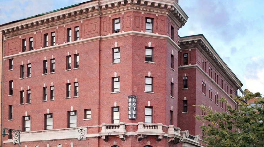 A ship-cabin-like room with brass fixtures and a porthole window