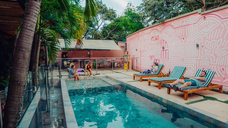 Anya Petrova in front of a colorful mural in Selina Medellin.